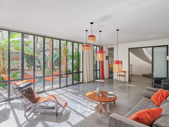 Interior of a house in Marseille 7th district with a bright living room and a view of a green patio.