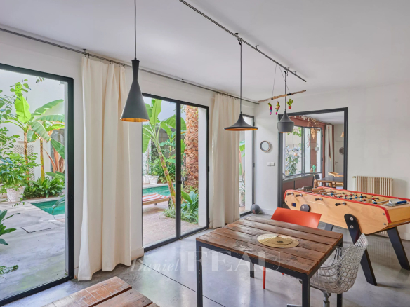 Interior of a house in Marseille 7th district with dining room table and leisure area.