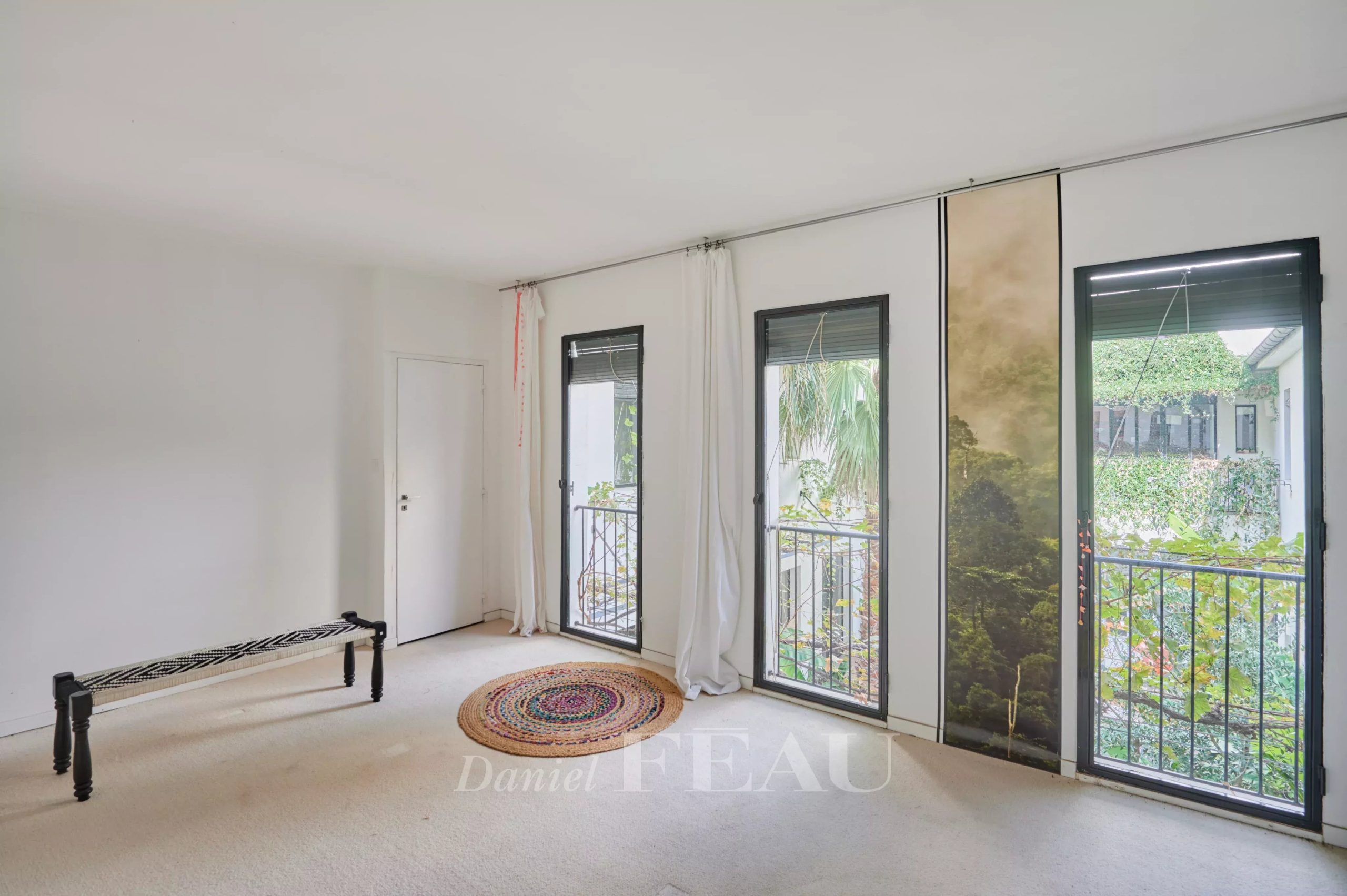 Interior of a house in Marseille's 7th arrondissement Interior of a house in Marseille 7th district with windows overlooking a green patio.