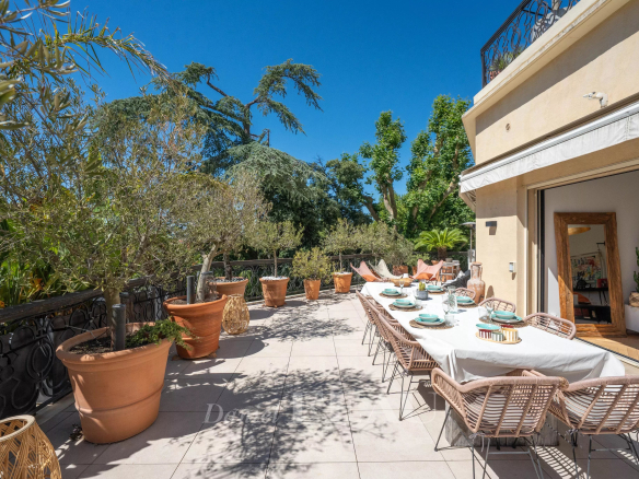 Terrasse d'un appartement avec tables dressées et plantes, Marseille 9ème.