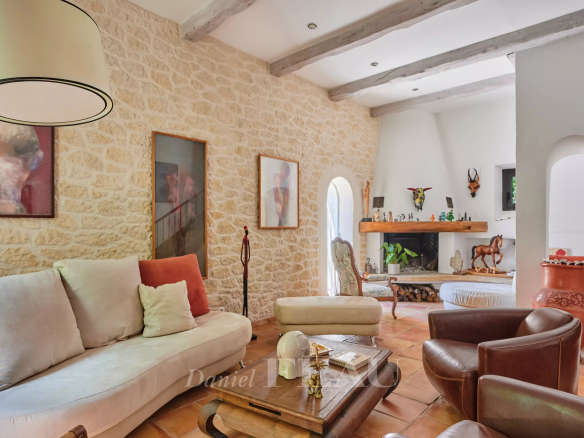 Interior of a charming house with a bright living room and stone walls.