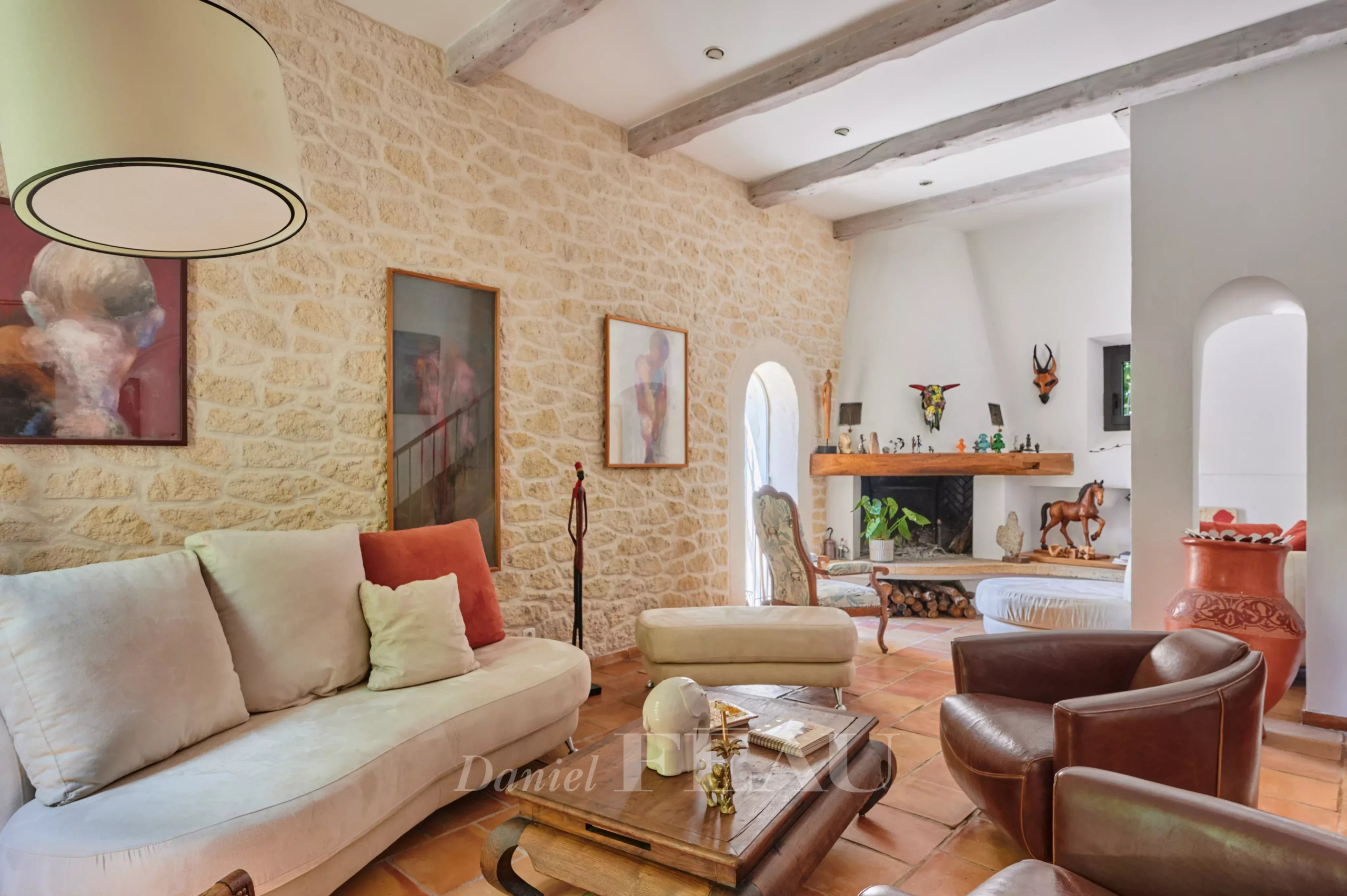 Living room of a charming house in Marseille Interior of a charming house with a bright living room and stone walls.
