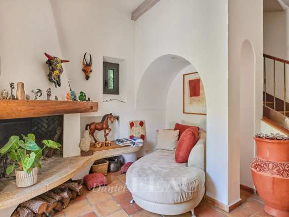 Interior of a charming house with fireplace, decorations and comfortable sitting area.