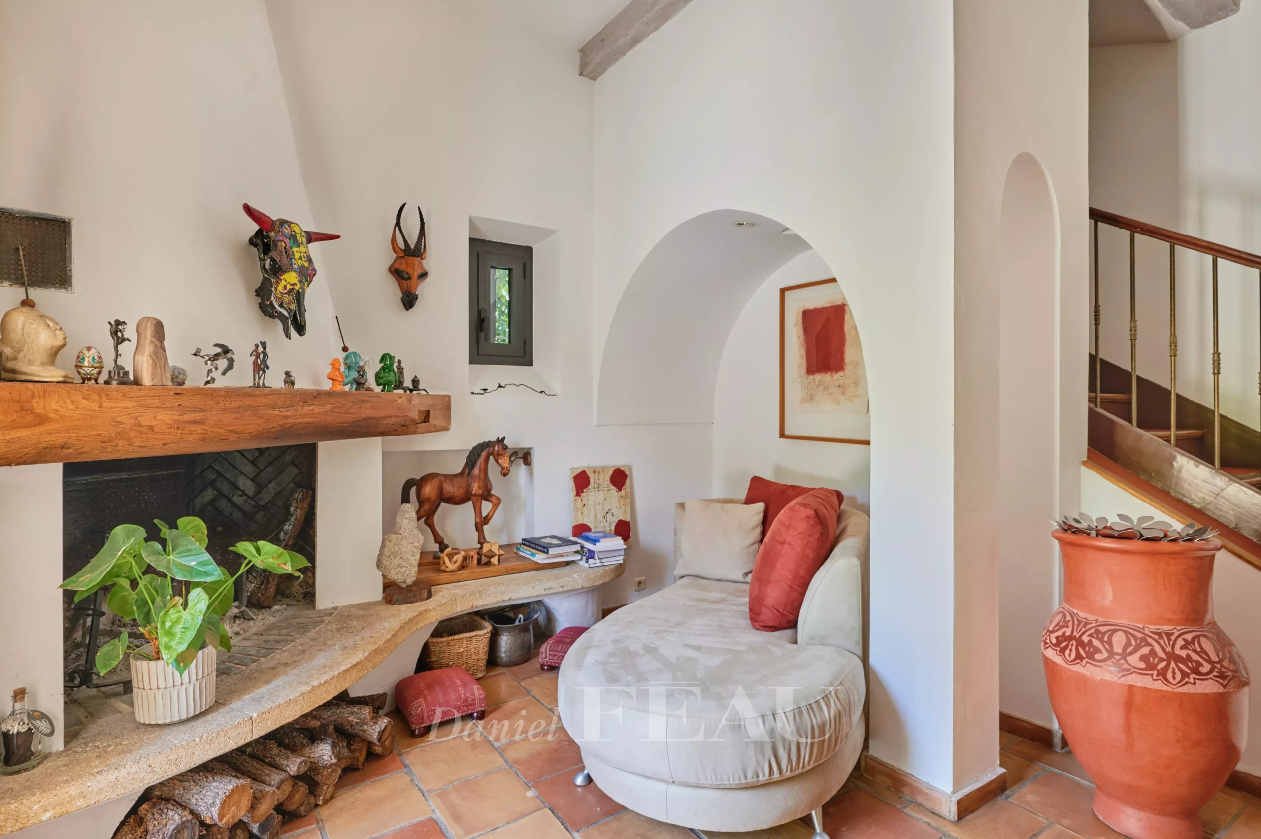 Interior of a charming house in Marseille Interior of a charming house with fireplace, decorations and comfortable sitting area.