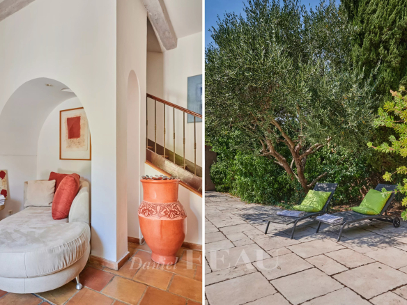 Interior of a house with a sitting area and an outdoor garden with sun loungers.