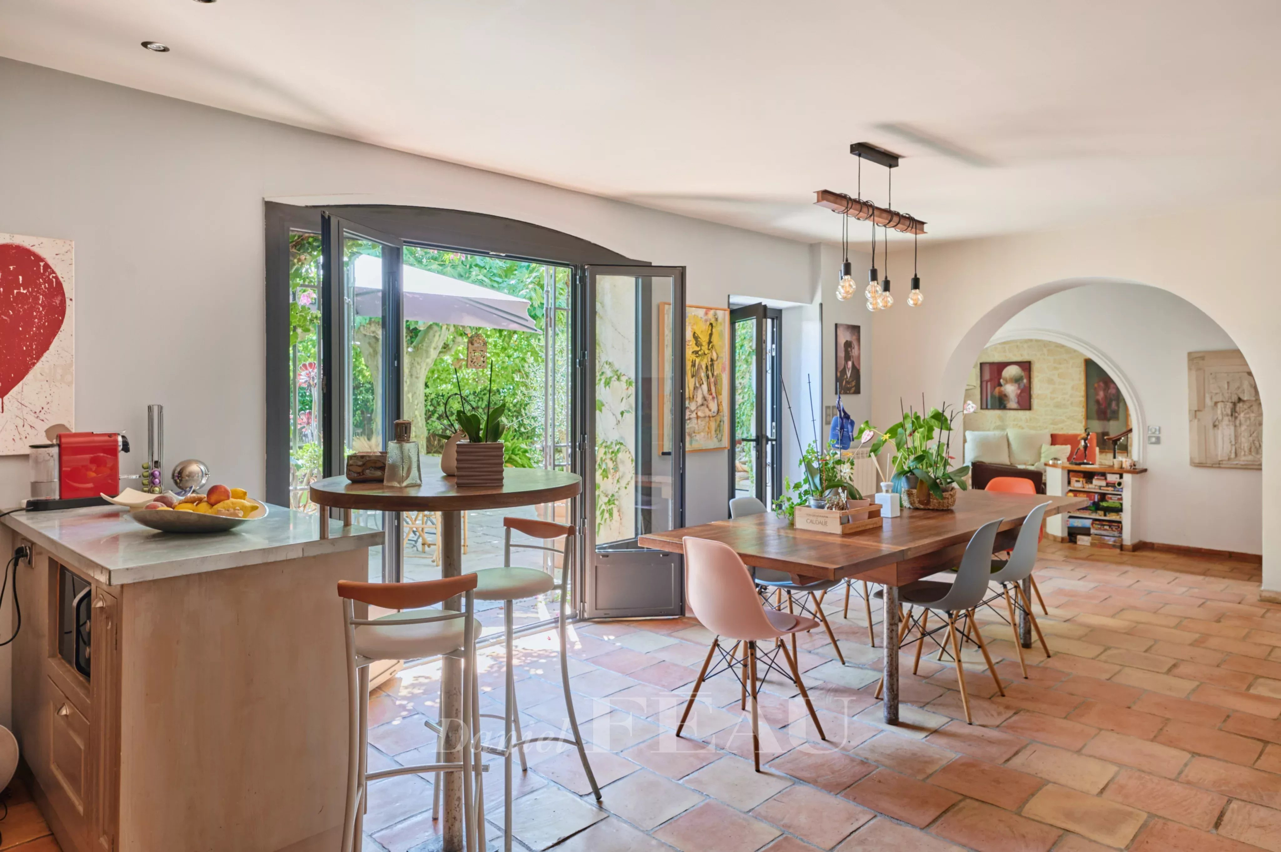 Interior of a charming house in Marseille Interior of a charming house with open kitchen and dining room, natural lighting.