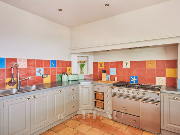 Kitchen in a charming house with colorful tiles and modern appliances.