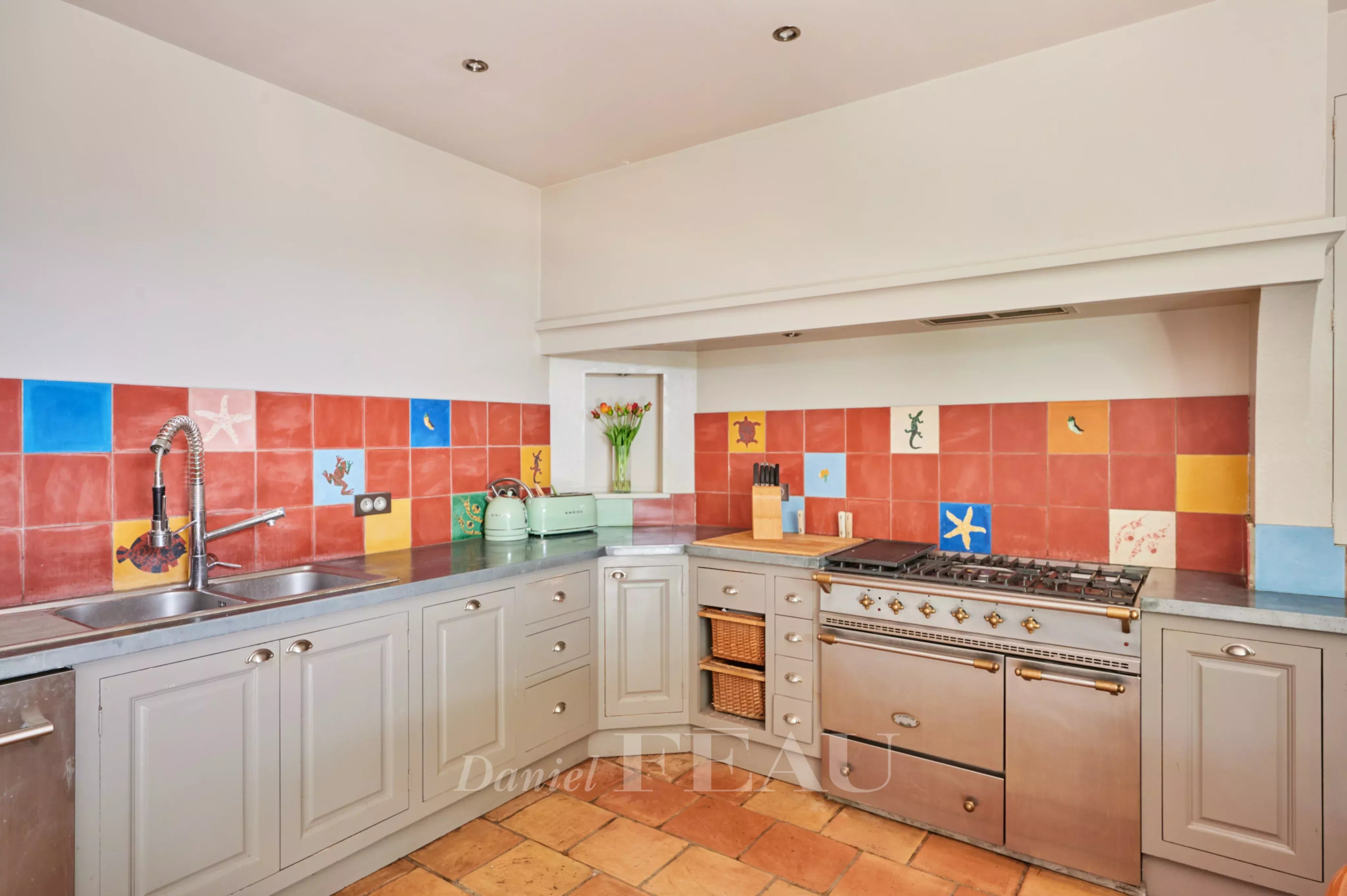 Charming home cooking in Marseille Kitchen in a charming house with colorful tiles and modern appliances.