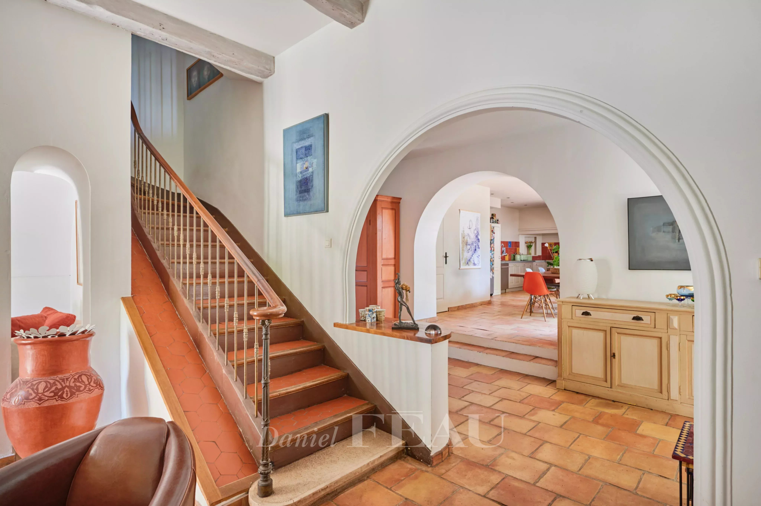 Charming house in Marseille Interior of a charming house with a wooden staircase and a bright living room.
