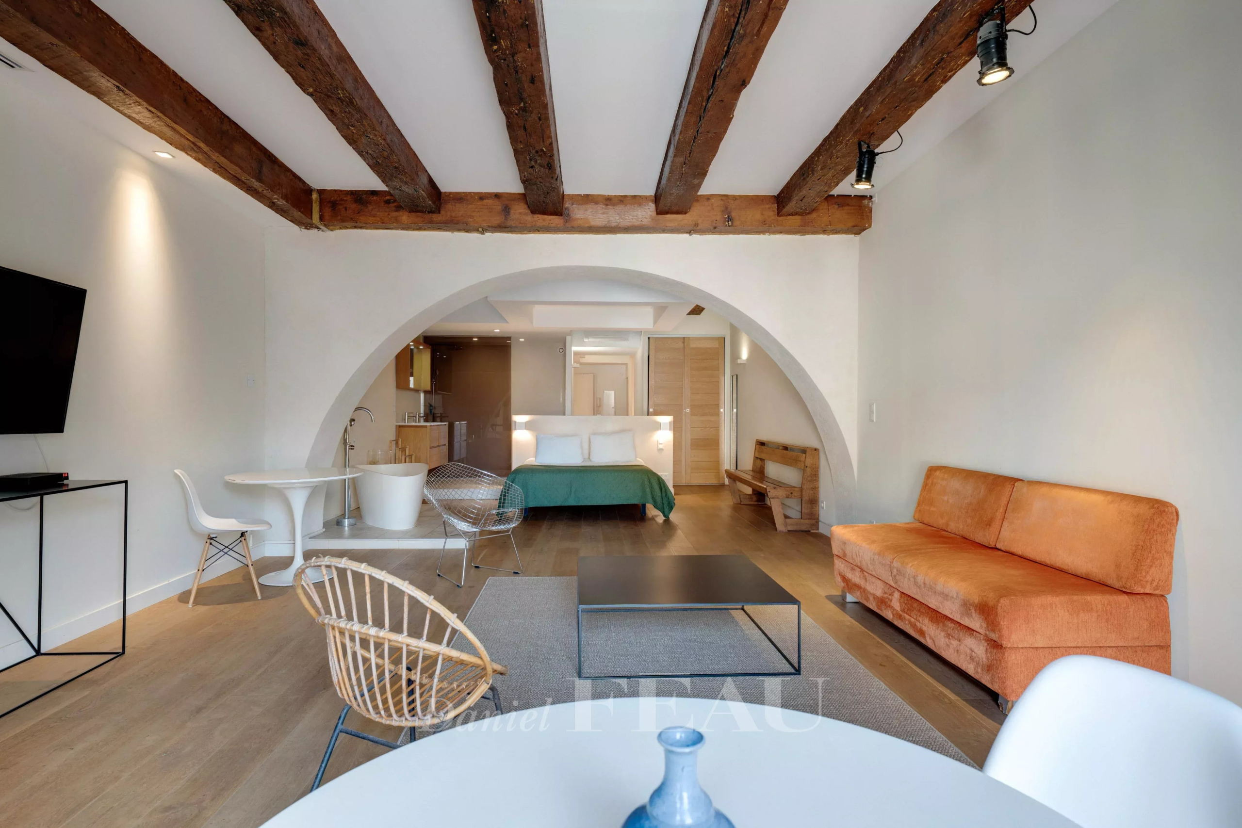 Interior of a loft in the Old Port of Marseille with exposed beams and modern furniture.
