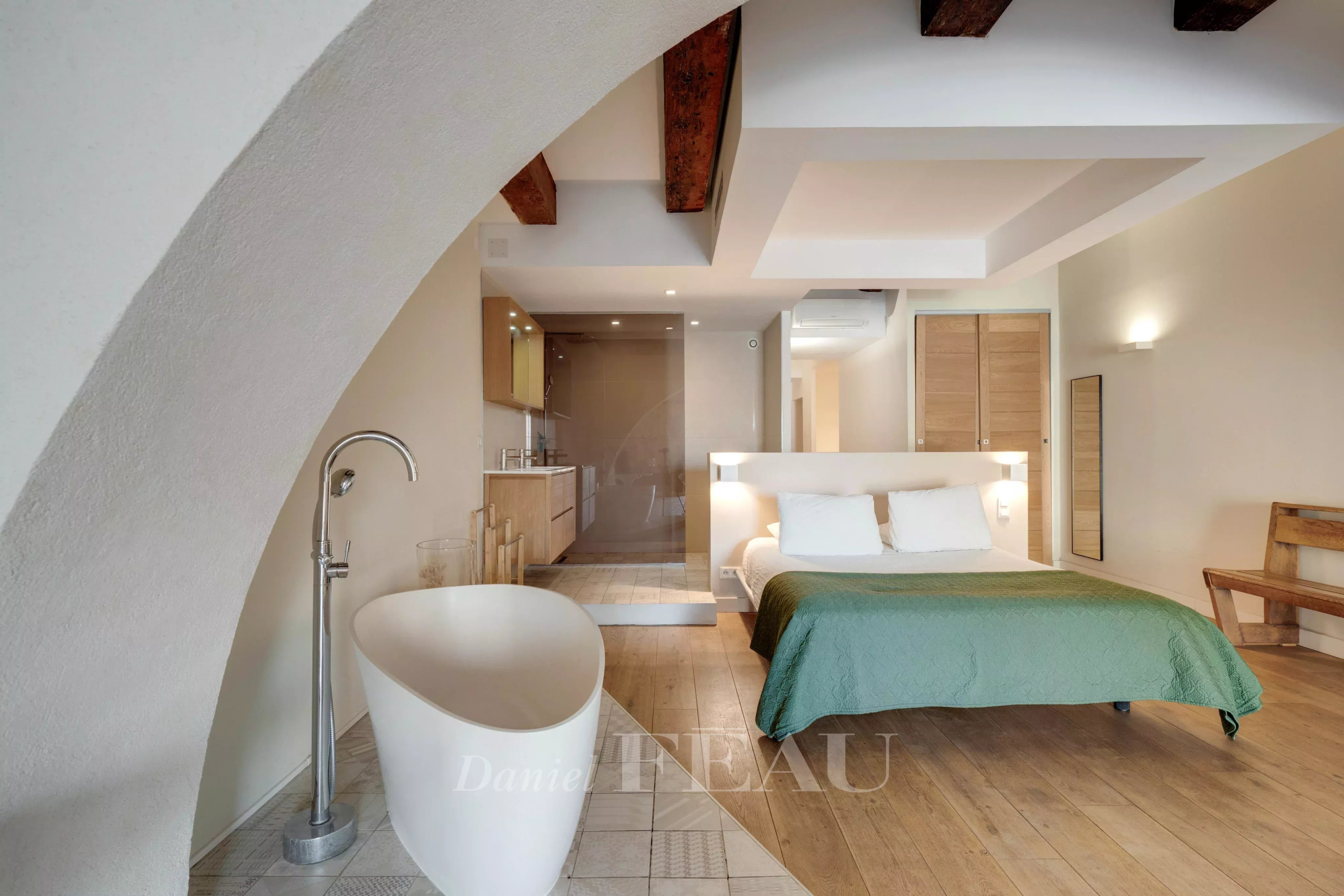 Modern loft with bed and bathtub in the Old Port of Marseille.