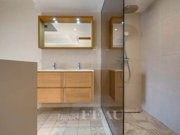 Modern bathroom with shower and wooden furniture in a loft in the Old Port of Marseille.