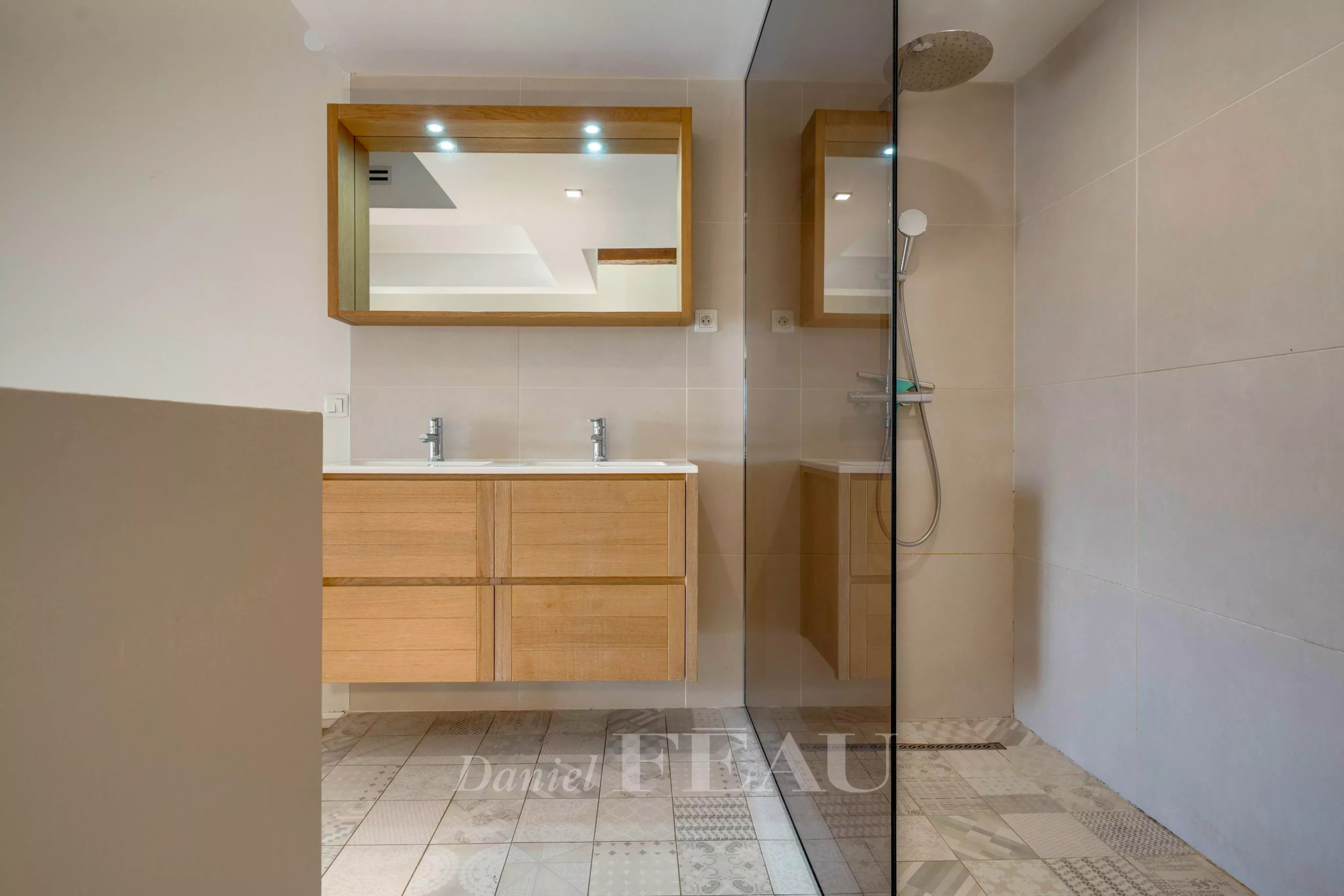 Modern bathroom with shower and wooden furniture in a loft in the Old Port of Marseille.