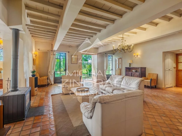 Interior of a characterful residence with a spacious living room and fireplace, elegantly decorated.