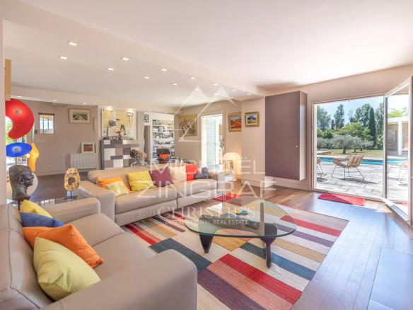 Bright interior of a property with a modern living room and access to the outside.