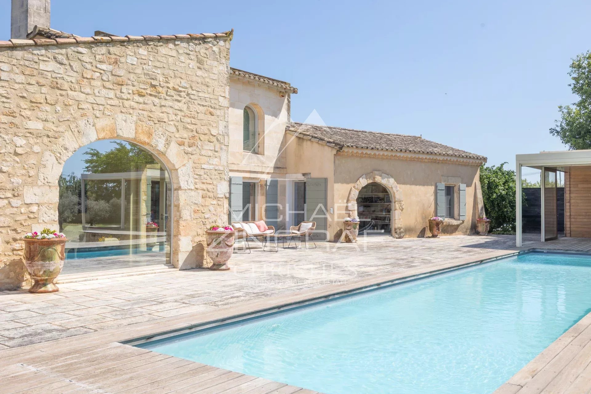 Exceptional property near Arles Property with swimming pool and stone facade near Arles, surrounded by greenery.
