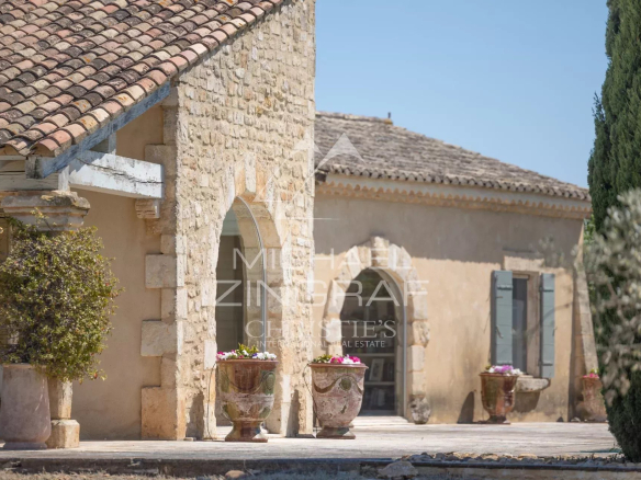 Stone house with garden, flower pots and Provençal architecture near Arles.