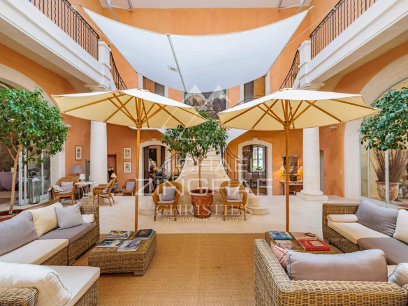 Interior of a Provençal property with sofas and parasols, refined decor.