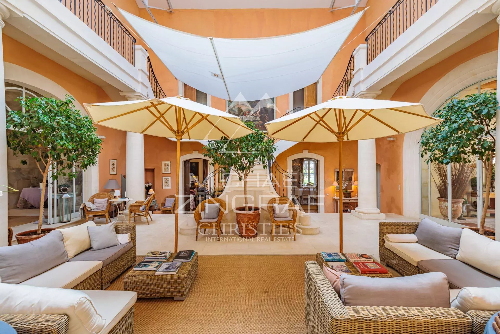 Interior of a Provençal property with sofas and parasols, refined decor.