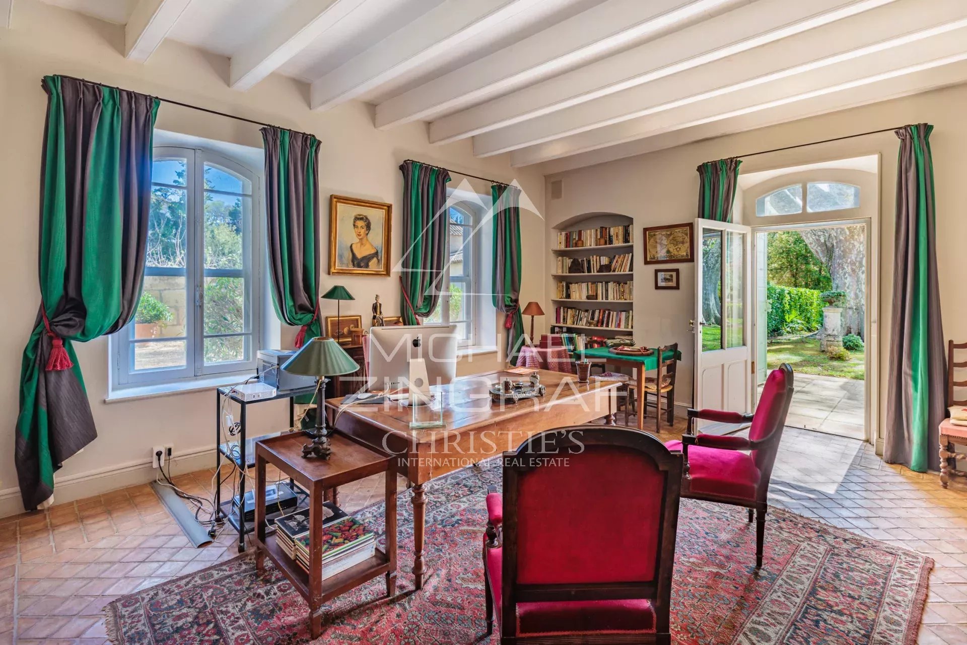 Interior of a Provençal property with bright windows and refined decor.