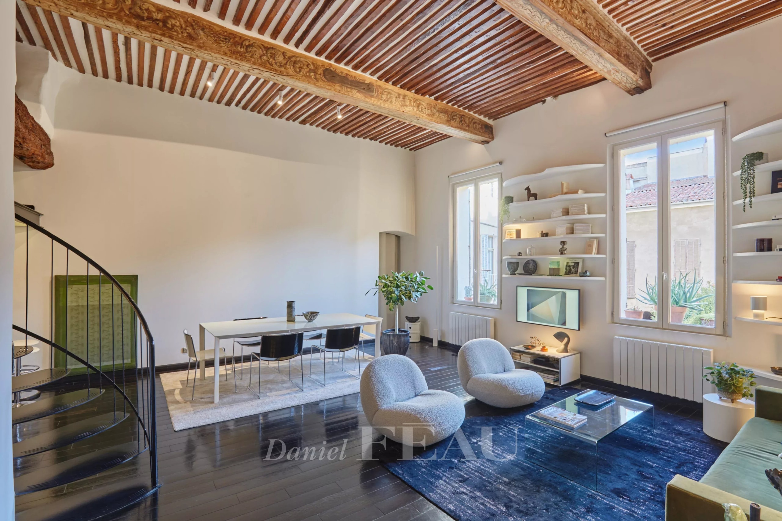 Intérieur d'un appartement au style contemporain avec poutres apparentes et mobilier moderne à Aix-en-Provence.