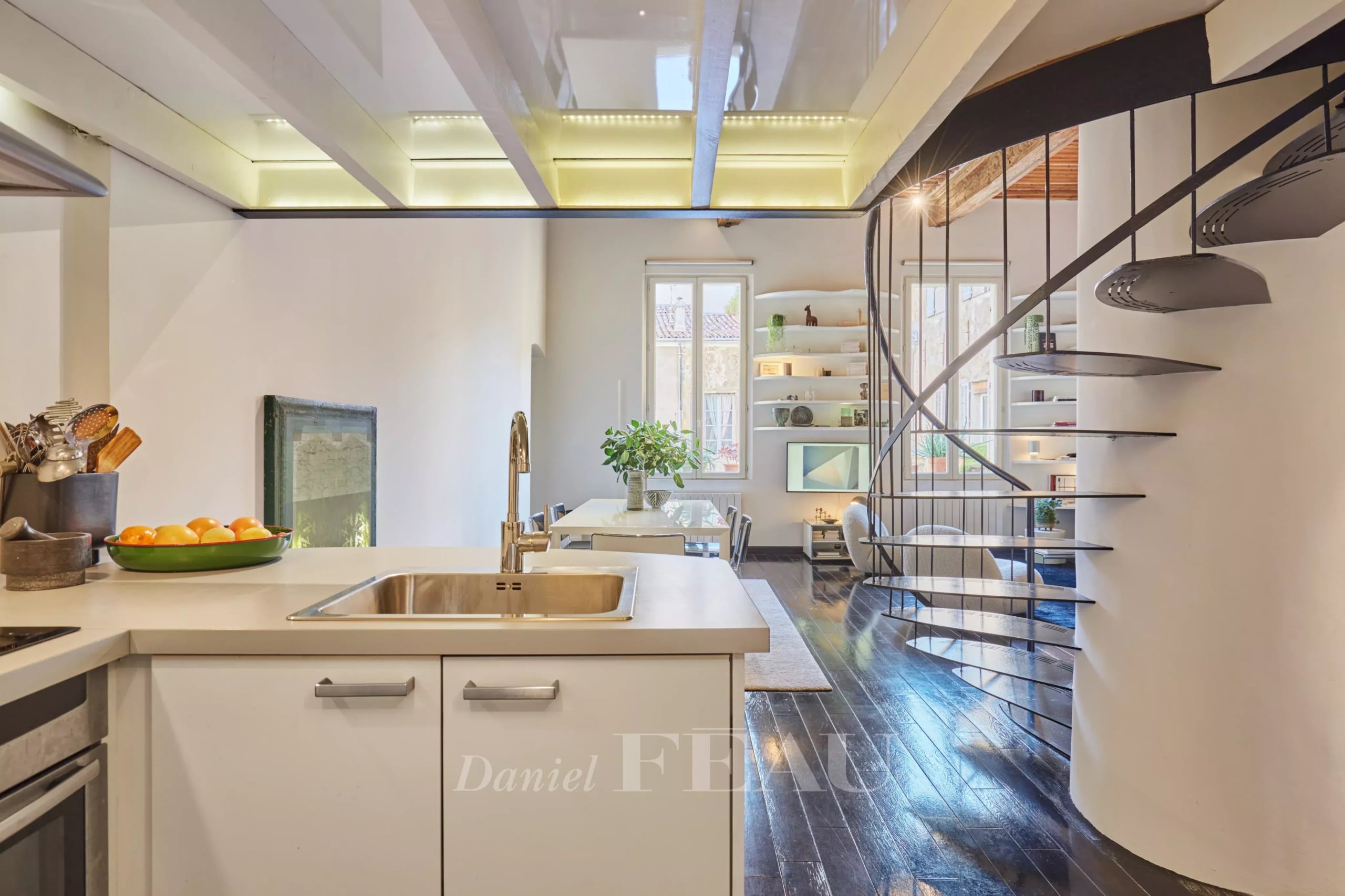 Cuisine moderne d'un appartement au centre historique d'Aix-en-Provence avec mezzanine et escalier design.