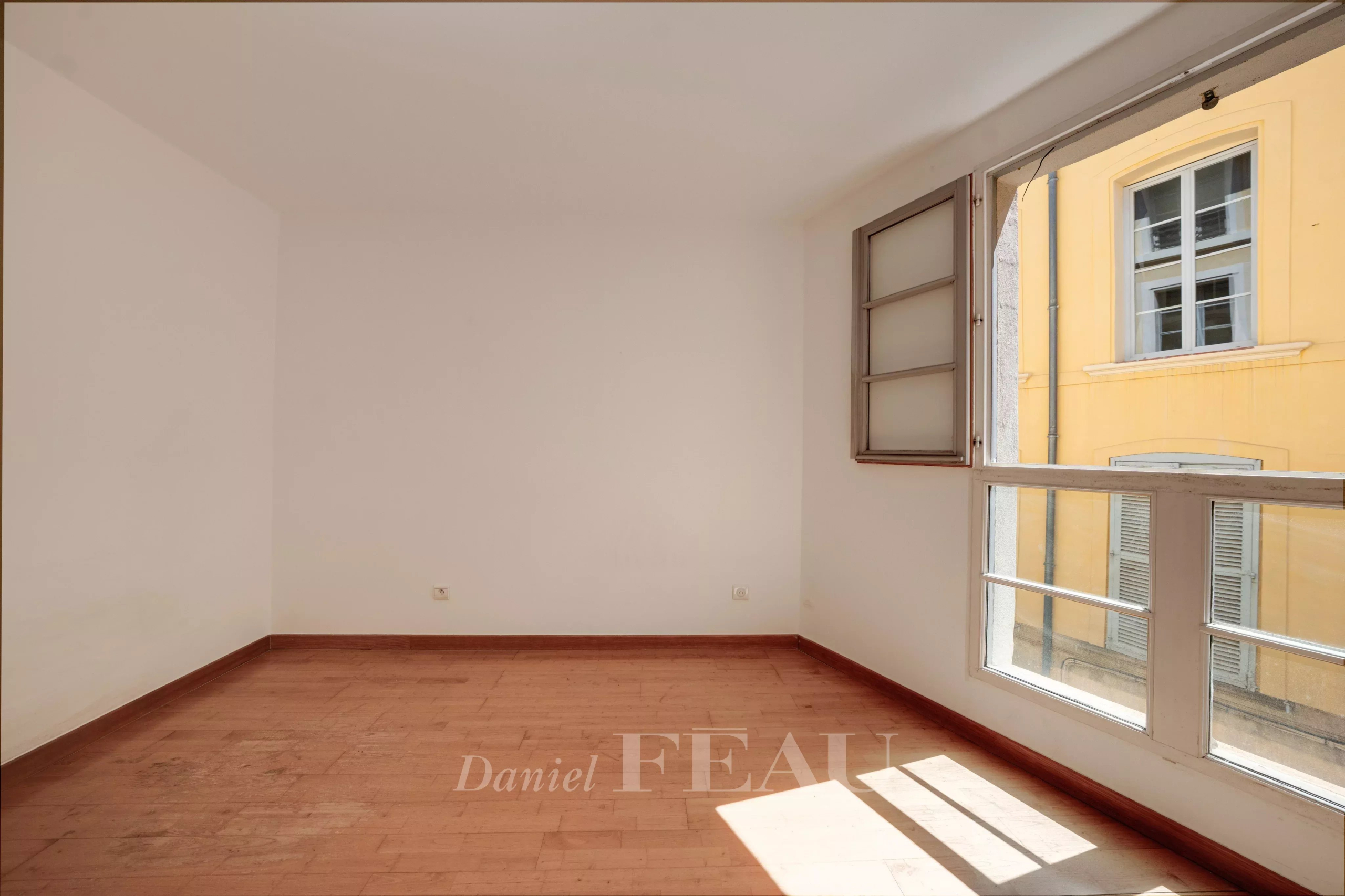 Appartement à Aix-en-Provence Intérieur d'un appartement à Aix-en-Provence avec lumière naturelle et fenêtres ouvertes.