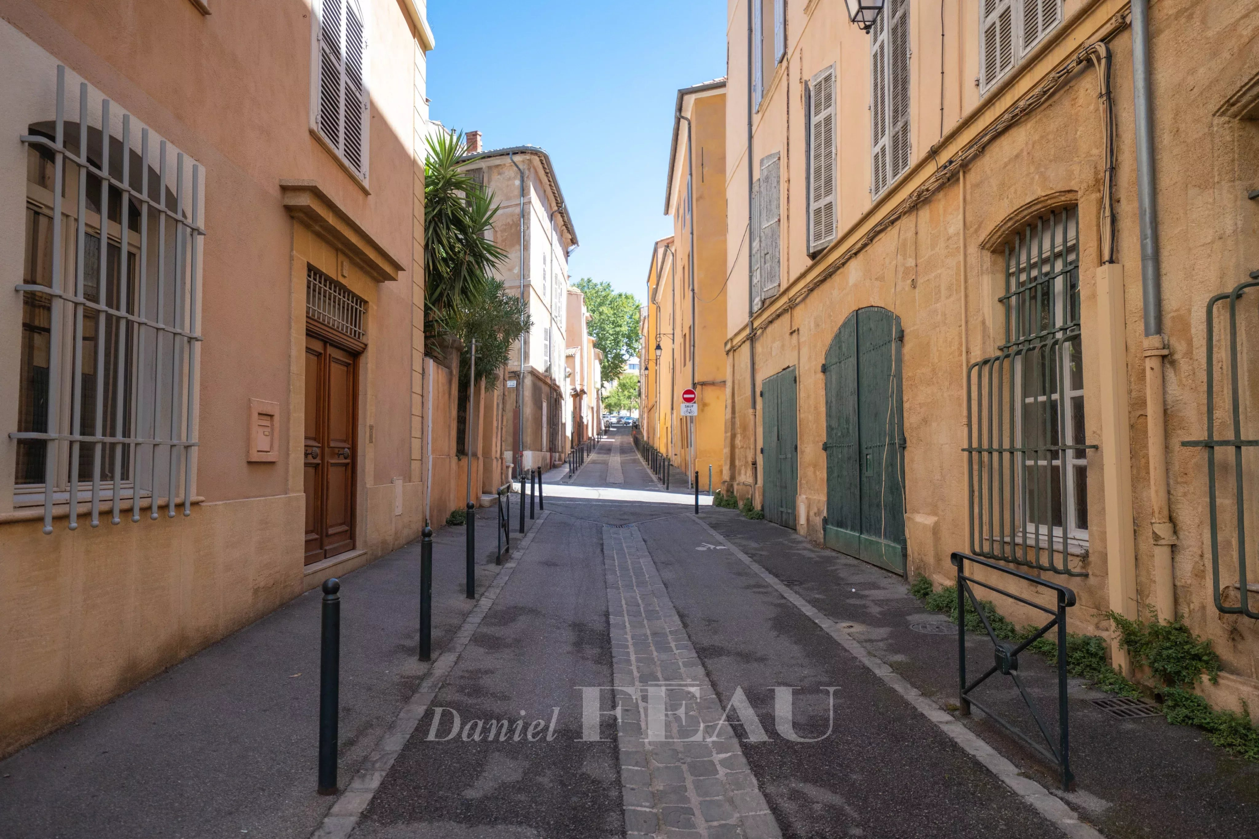 Rue historique à Aix-en-Provence Rue calme du centre historique d'Aix-en-Provence, avec bâtiments en pierre et végétation.