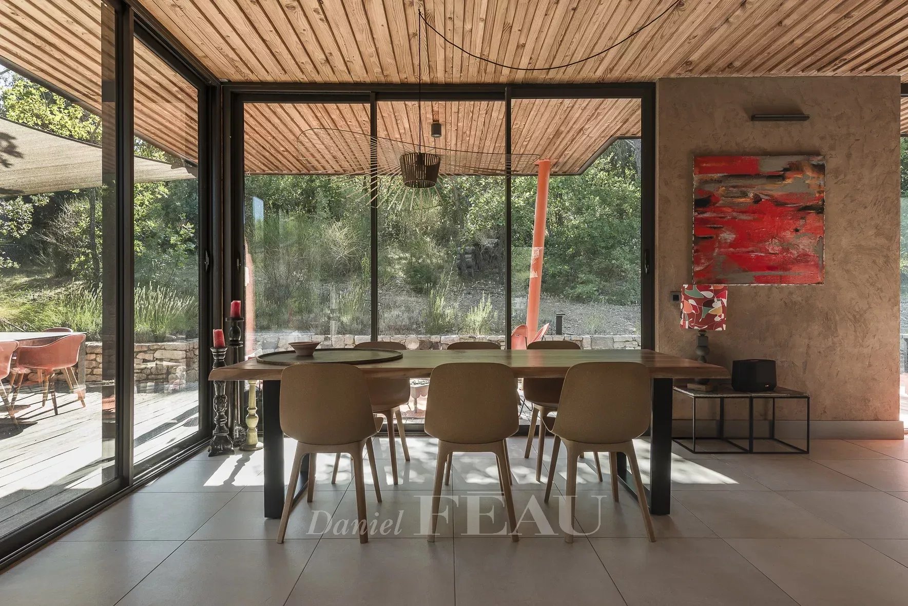Modern interior of an architect-designed house Interior of an architect-designed house with a large dining table and chairs, overlooking a garden.