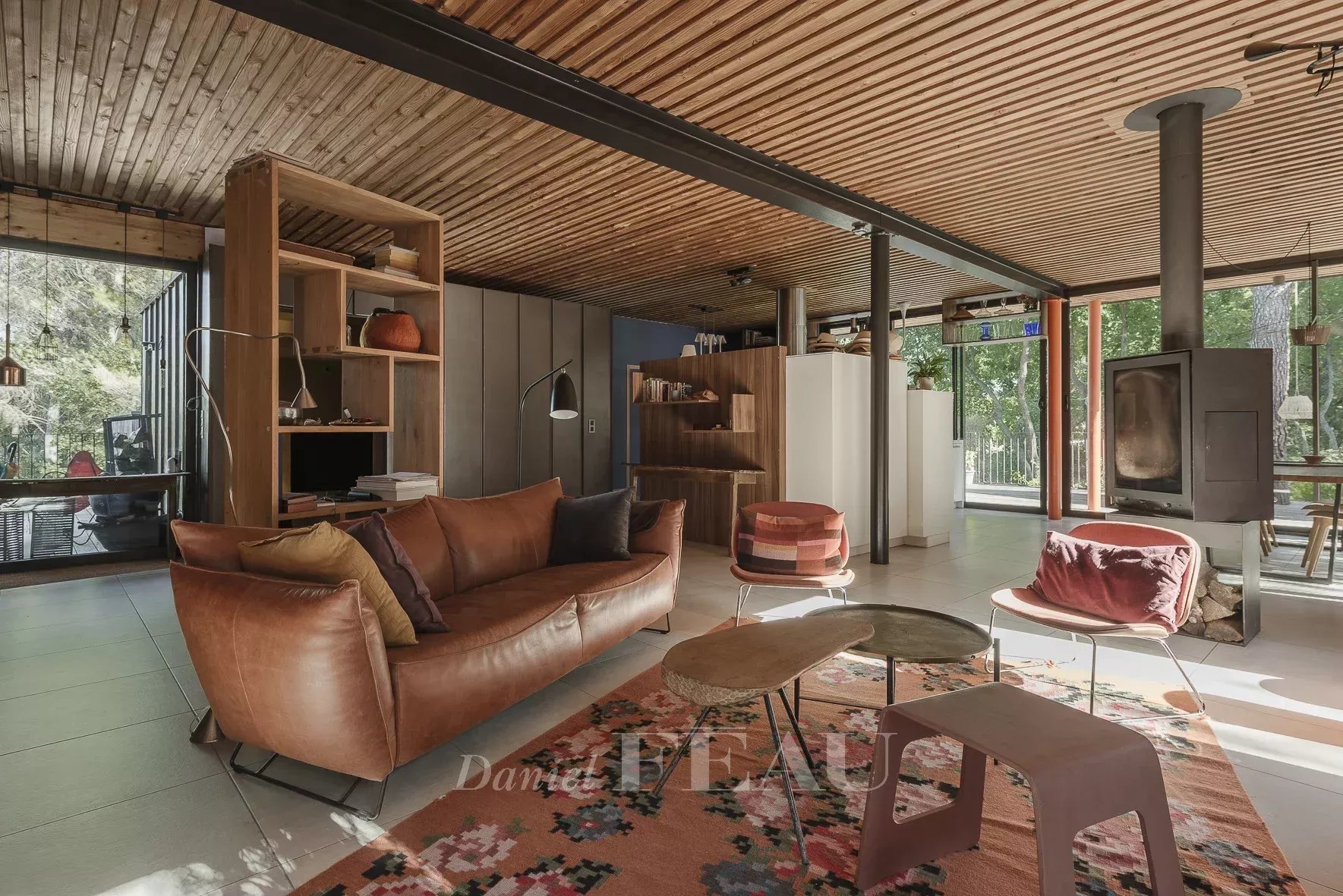 Interior of an architect-designed house Interior of an architect-designed house with a modern living room and fireplace, surrounded by nature.