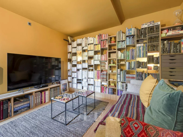 Interior of an architect-designed house with a library and comfortable living room.