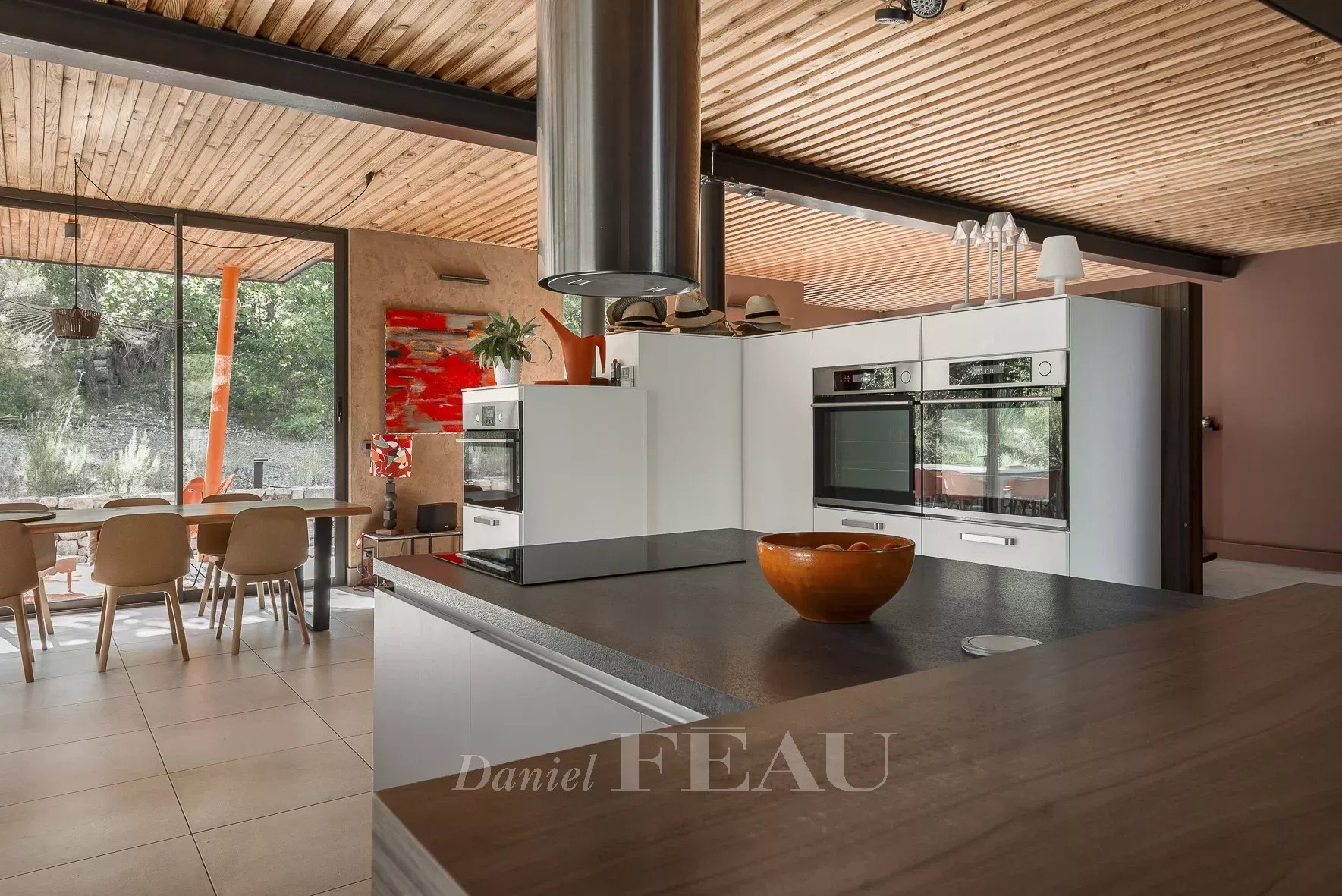 Interior of an architect-designed house Interior of a modern architect-designed house with open kitchen and dining room, Aix-en-Provence.