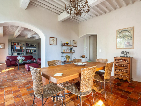 Interior of an 18th-century stone house with a wooden table and wicker chairs.