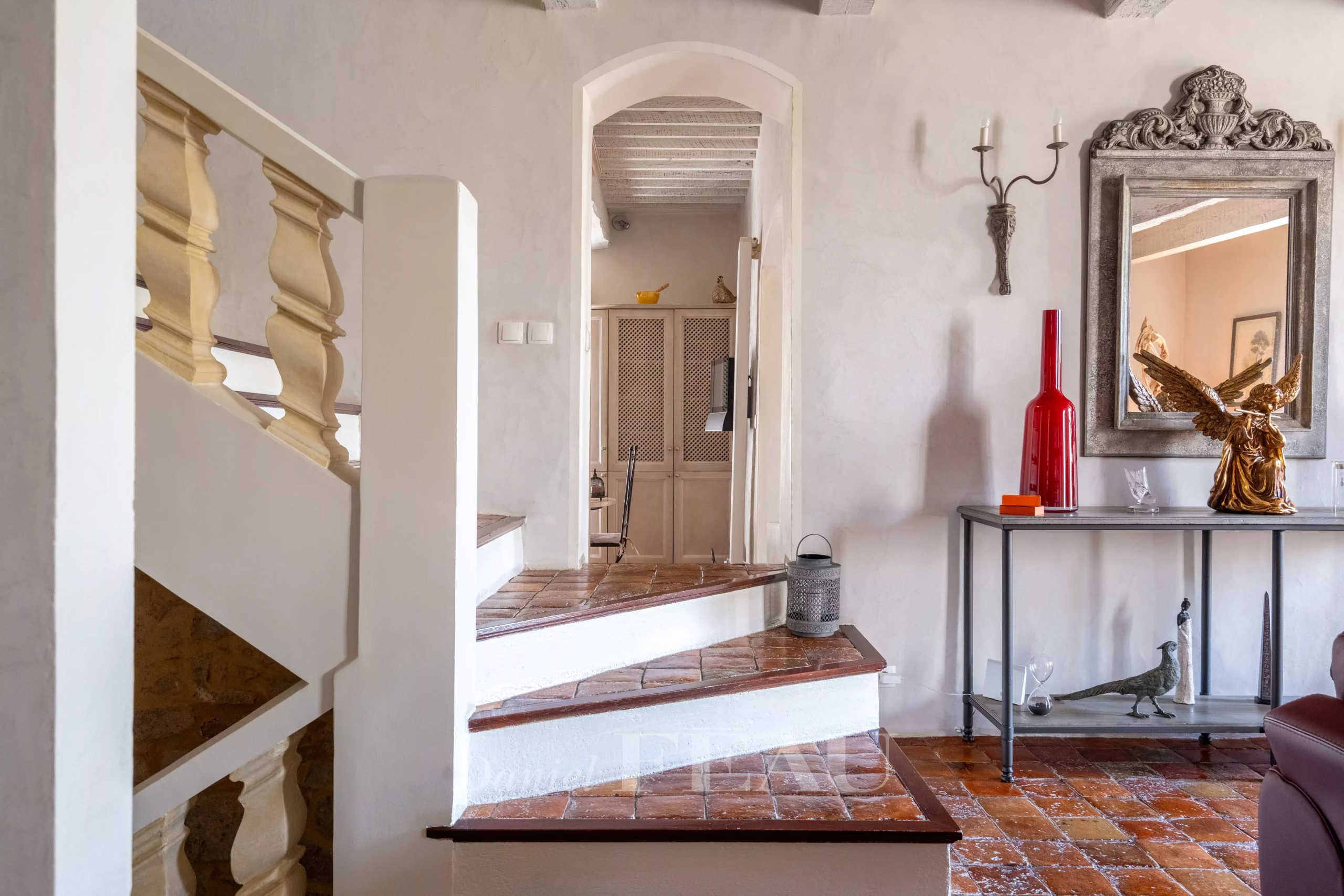 Interior of an 18th-century stone house Stone staircase with wooden railing in a restored old house.