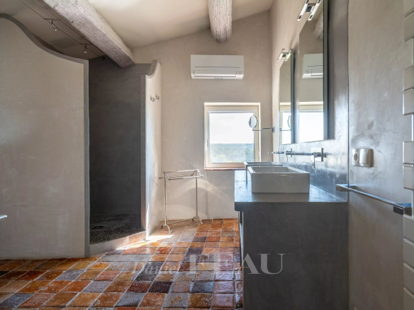 Modern bathroom with shower and views of nature, in an 18th century stone house.