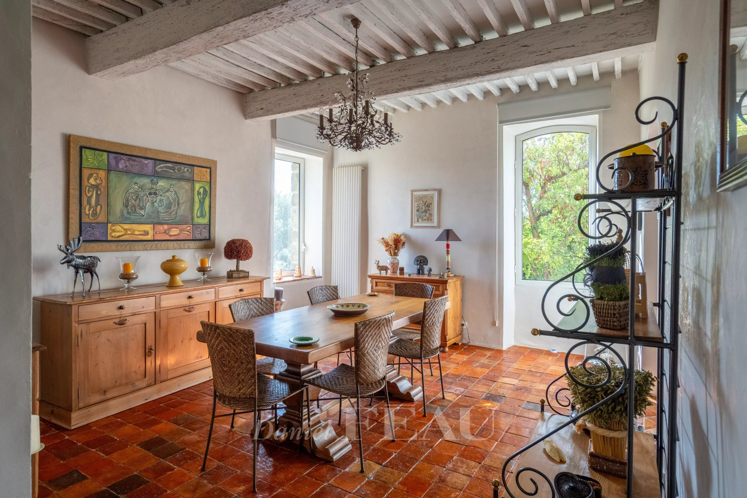 Dining room of a restored rectory Dining room of a former 18th-century stone presbytery with wooden furniture and terracotta tiles.