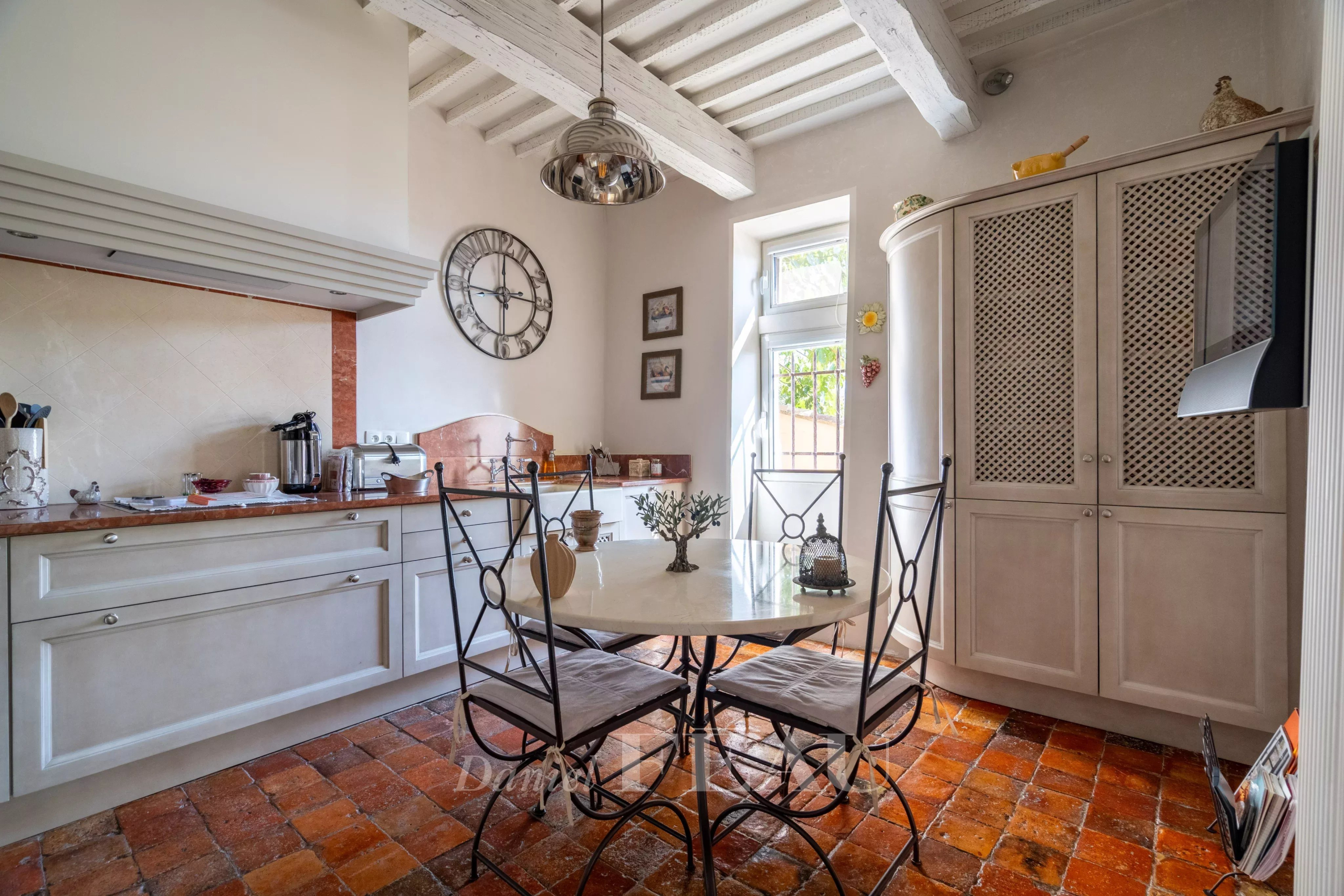 Kitchen of a restored rectory Kitchen of an old 18th-century stone presbytery, with wrought iron table and chairs.