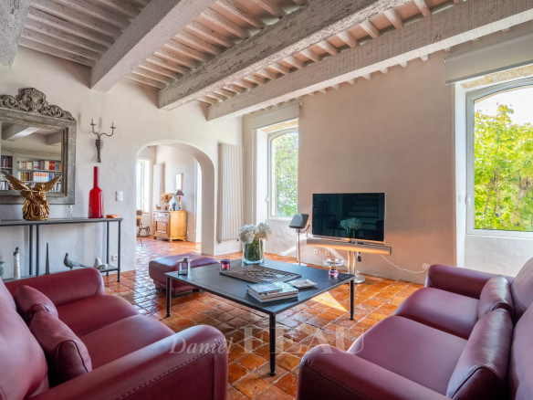 Interior of an old stone presbytery with living room and view of nature.