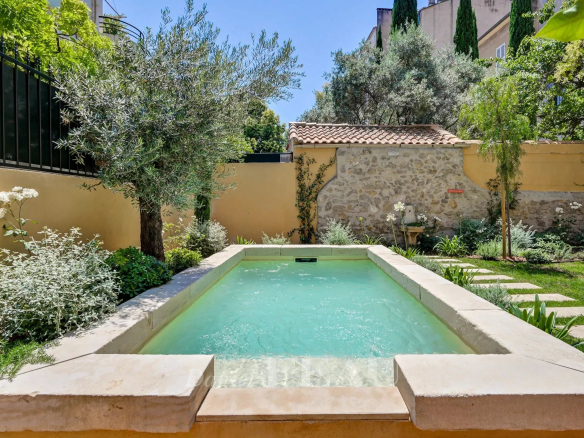 Private garden with swimming pool and lush vegetation in Aix-en-Provence.