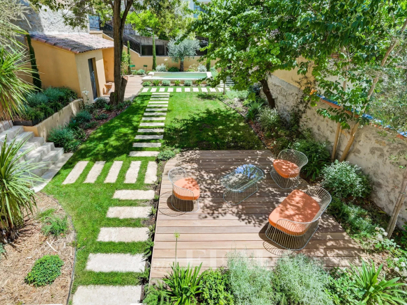 Private garden of an apartment in Aix-en-Provence with terrace and swimming pool.