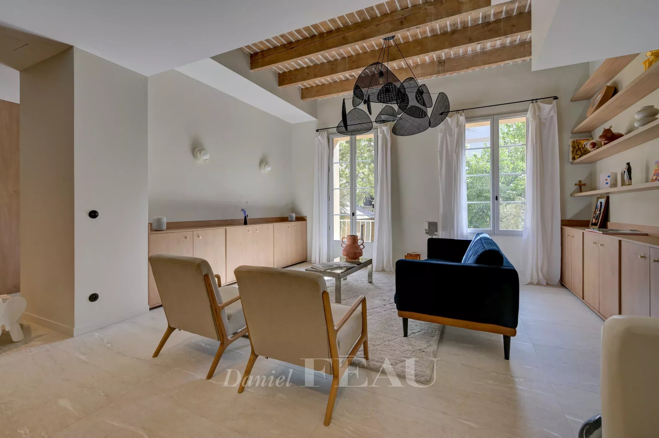 Renovated duplex in Aix-en-Provence Interior of a duplex in Aix-en-Provence with a bright living room and contemporary furniture.
