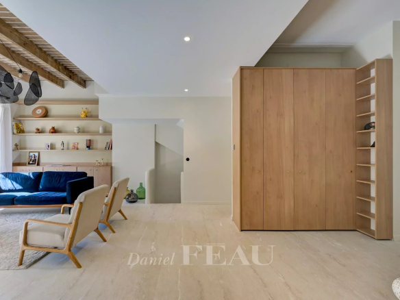 Interior of a renovated apartment with living room, wooden furniture and bright space in Aix-en-Provence.