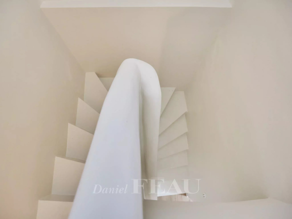 White spiral staircase in an apartment in Aix-en-Provence.