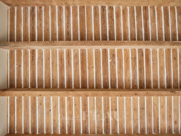 Wooden ceiling with exposed beams in a renovated apartment in Aix-en-Provence.