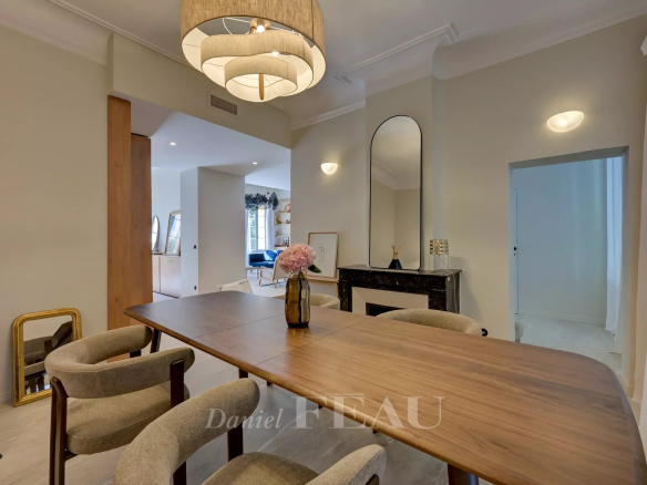 Interior of a renovated duplex apartment in Aix-en-Provence, with a wooden table and modern chairs.