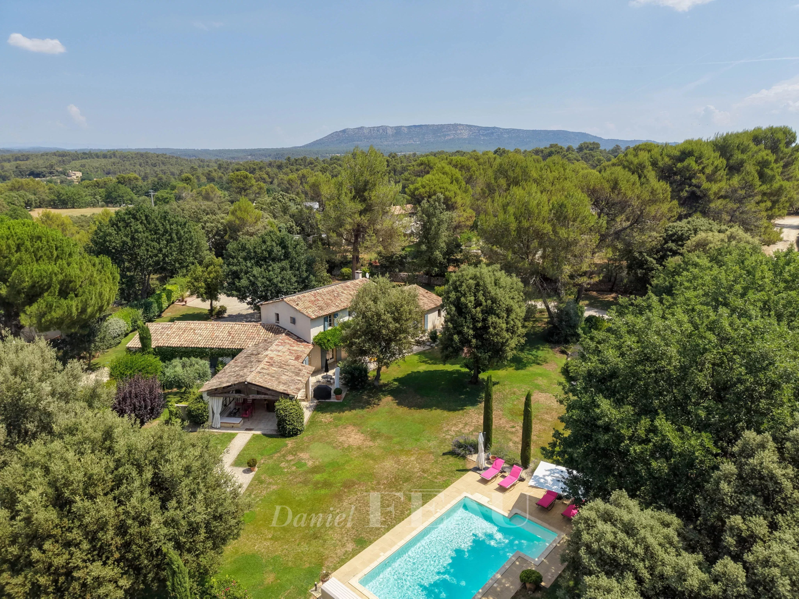 Mas ancien avec piscine à Aix-en-Provence Vue aérienne d'un mas ancien avec piscine, parc paysager et montagnes en arrière-plan à Aix-en-Provence.