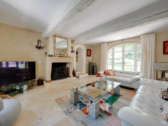 Intérieur d'un mas ancien à Aix-en-Provence avec salon lumineux et cheminée.