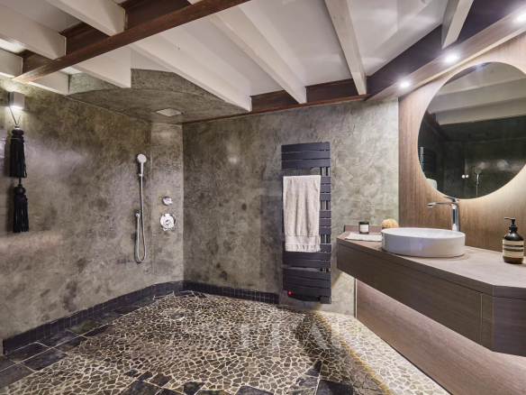 Modern bathroom with shower, sink and stone floor in an apartment in Aix-en-Provence.