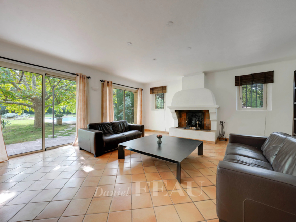 Salon lumineux d'une maison familiale à Aix-en-Provence avec cheminée et accès au jardin.
