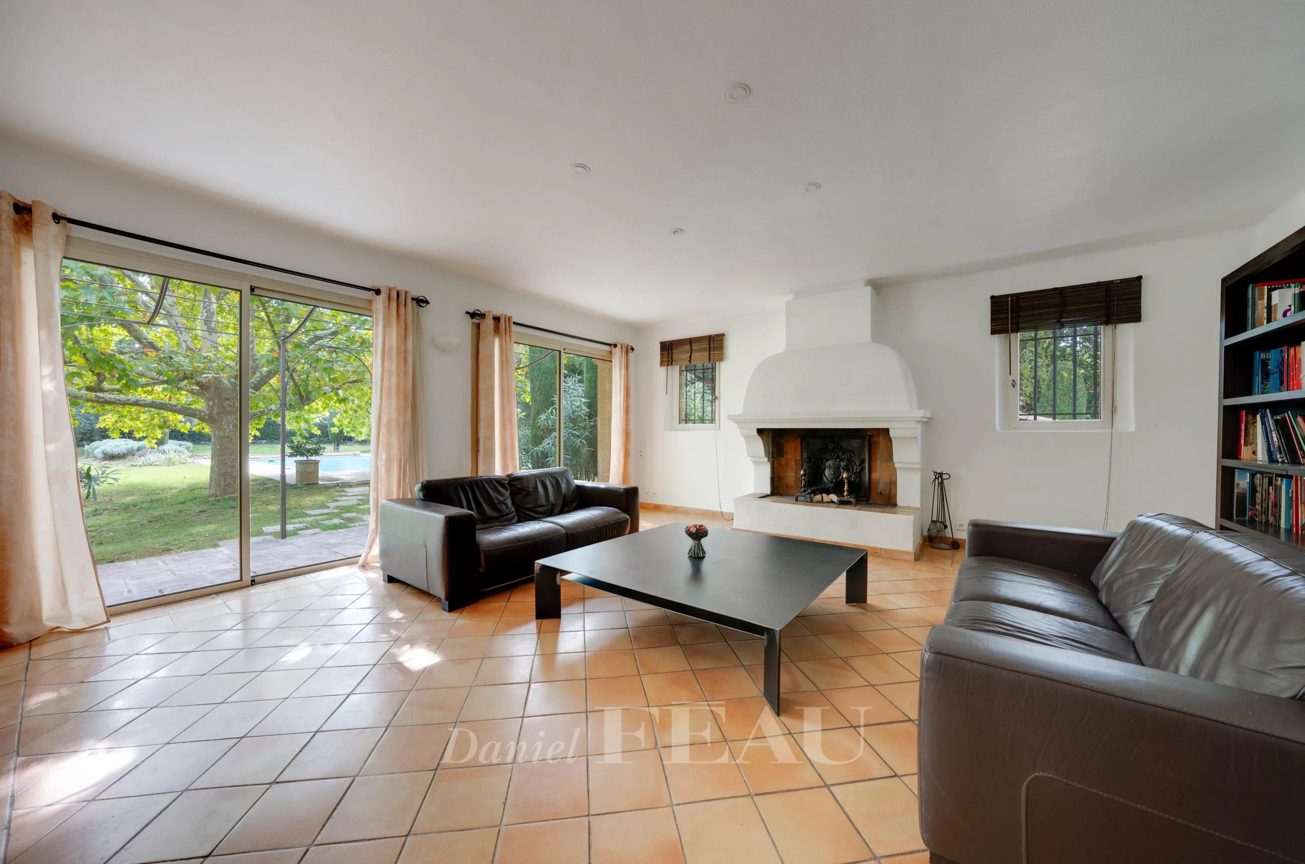 Salon lumineux d'une maison familiale à Aix-en-Provence avec cheminée et accès au jardin.